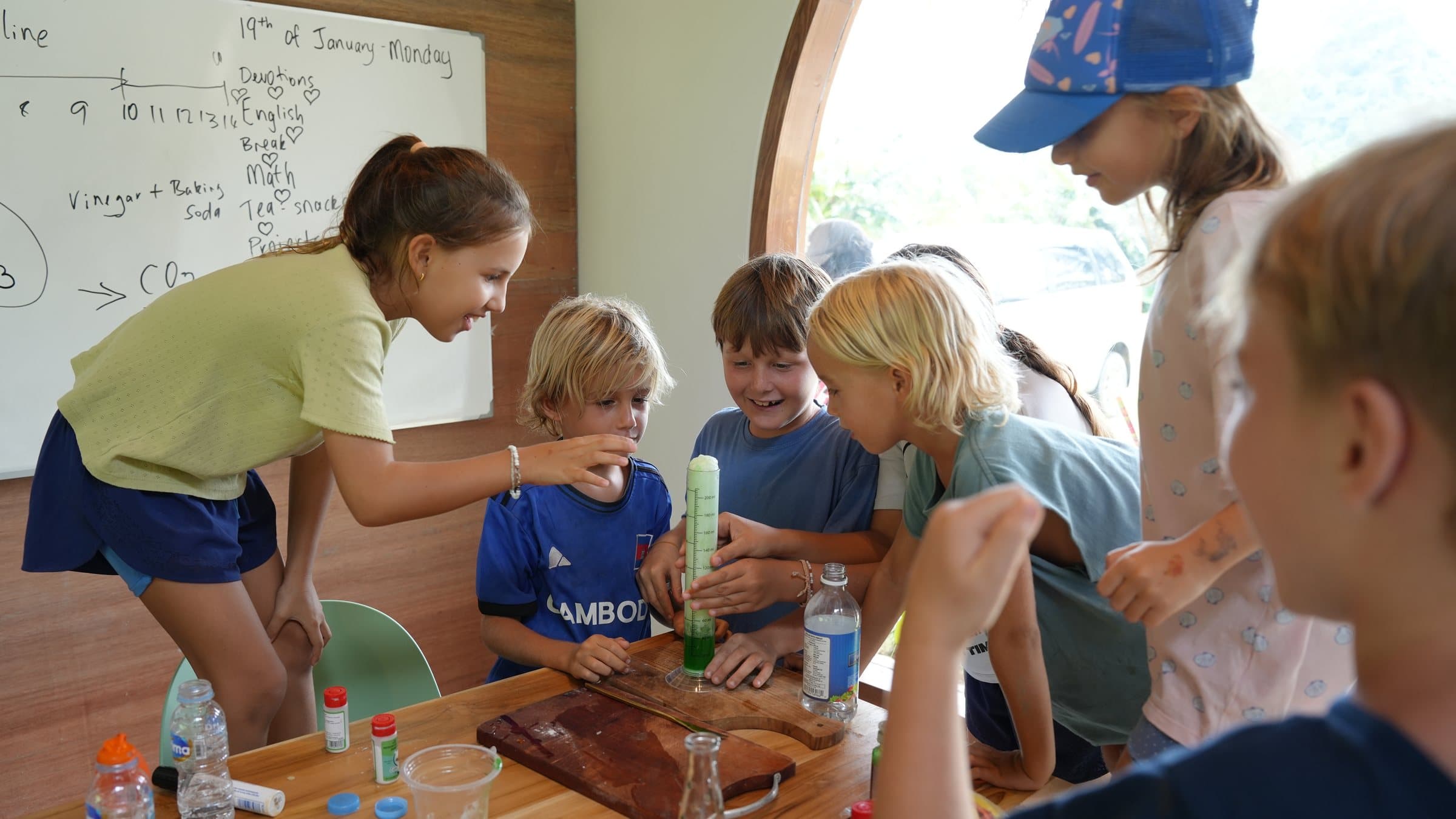 Students gathered around a science experiment at Selong Bay School