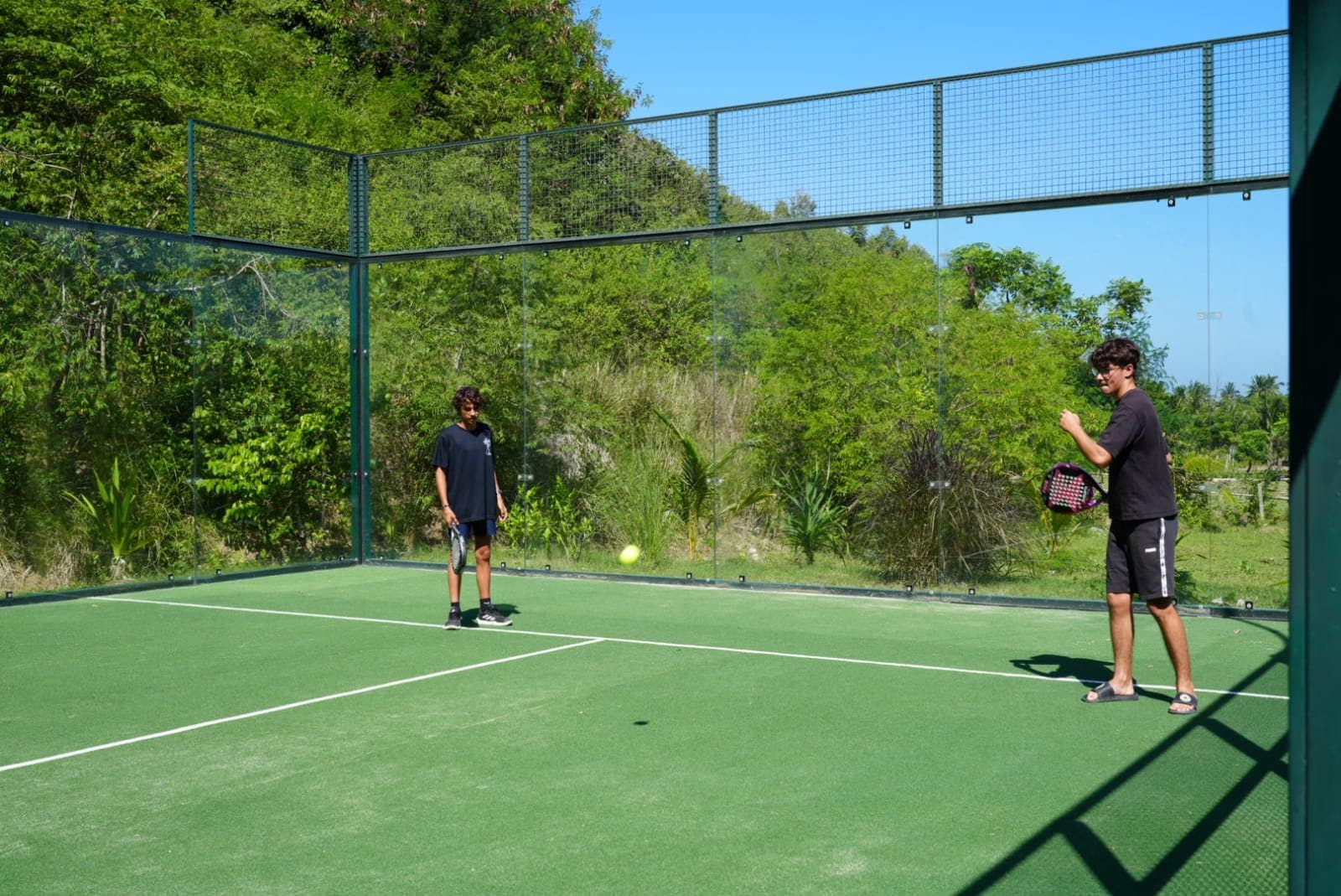 Older students playing padel on the school court
