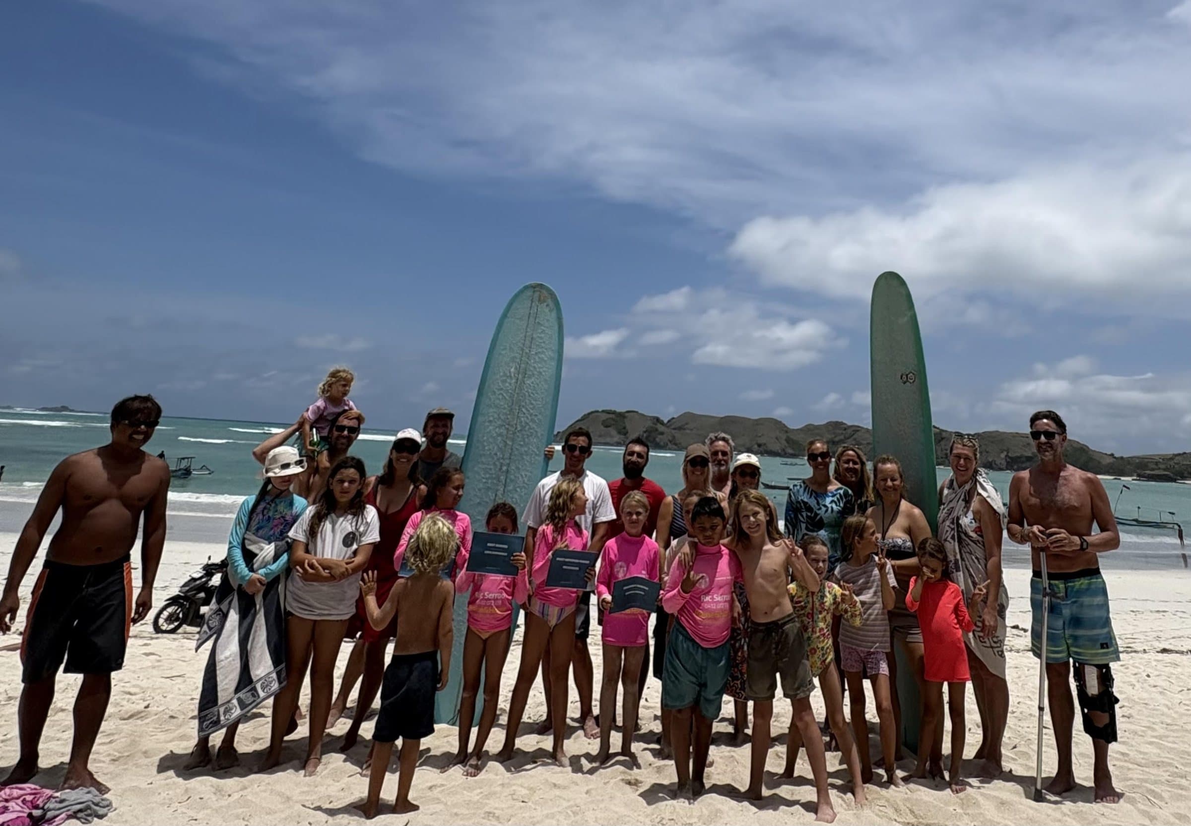 Selong Bay School students and families gathered on the beach after a surf session