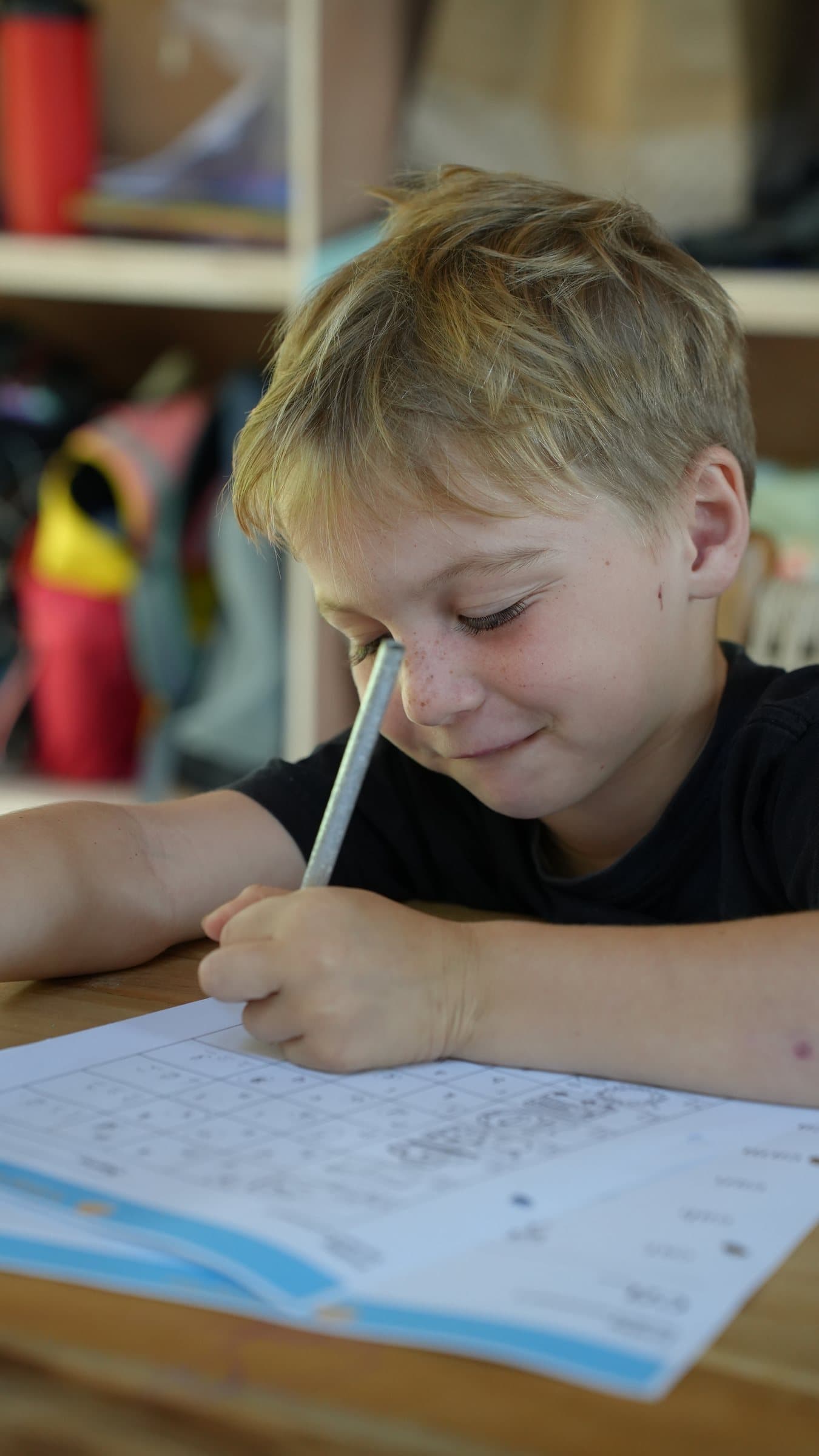 A student completing classwork at Selong Bay School