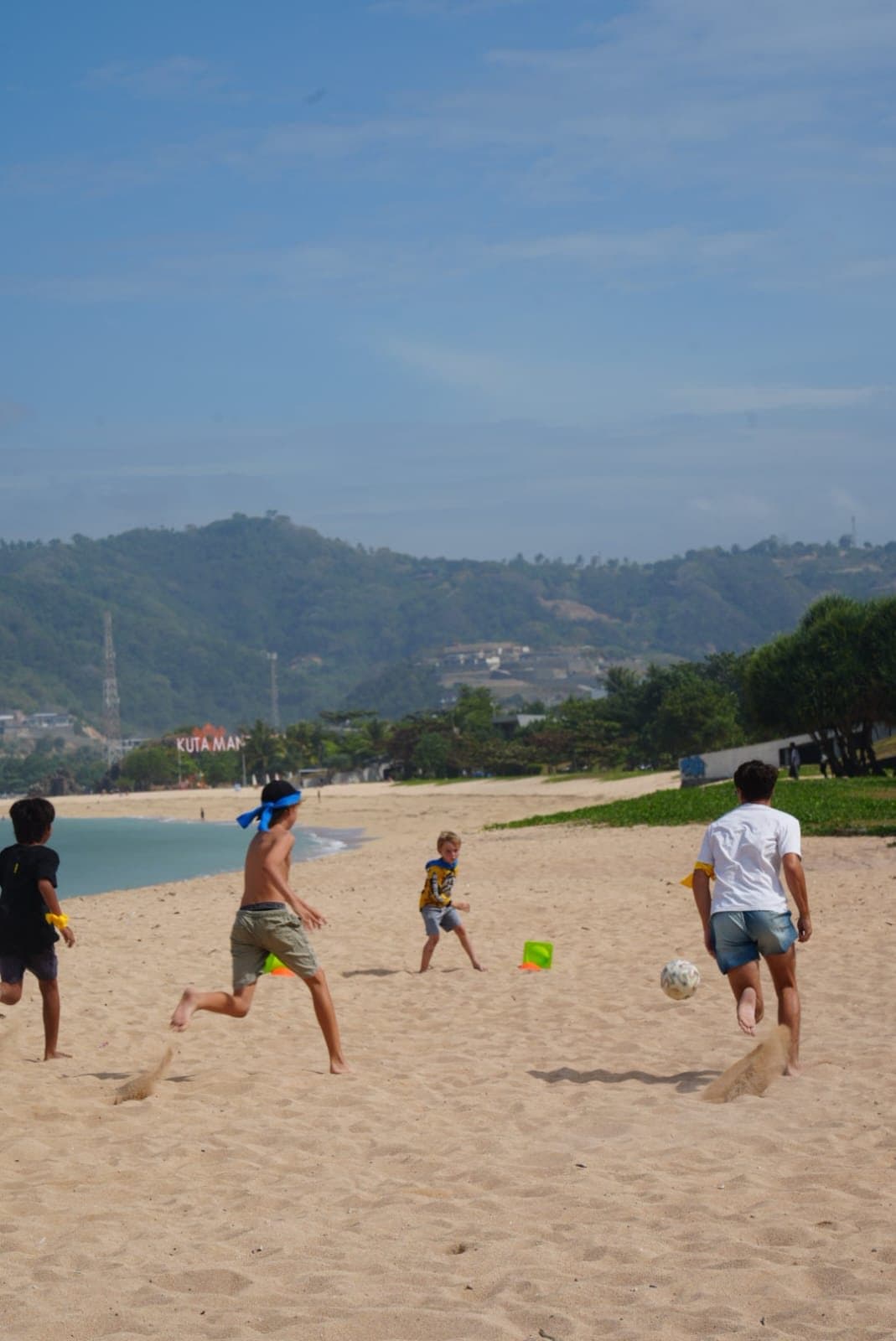 Students playing football on the beach near Kuta, Lombok
